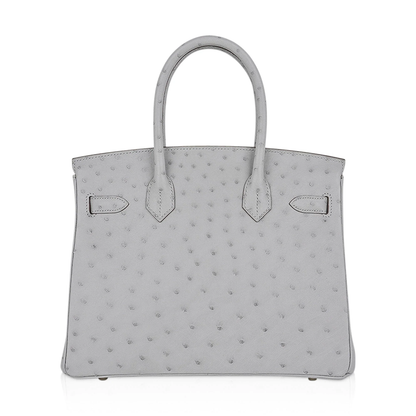 Soft Pearl Ash Grey Dotted Textured Structured Hand Tote With Glossy Golden Twist Lock Hardware, Matching Suspended Lock Charm And Base Protective Metal Studs