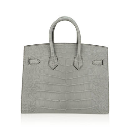 Muted Concrete Grey Large Scale Embossed Compact Sellier Hand Tote With Sharp Tailored Seams, Polished Golden Twist Lock Hardware And Matching Suspended Lock Charm